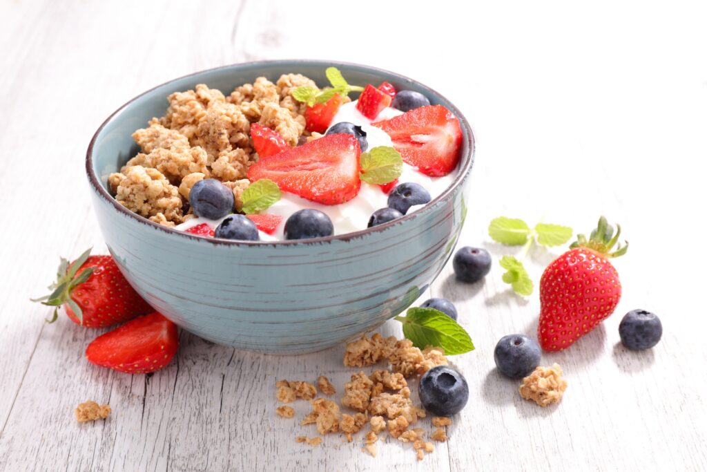 complex carbohydrates: breakfast bowl with granola with greek yogurt and berries