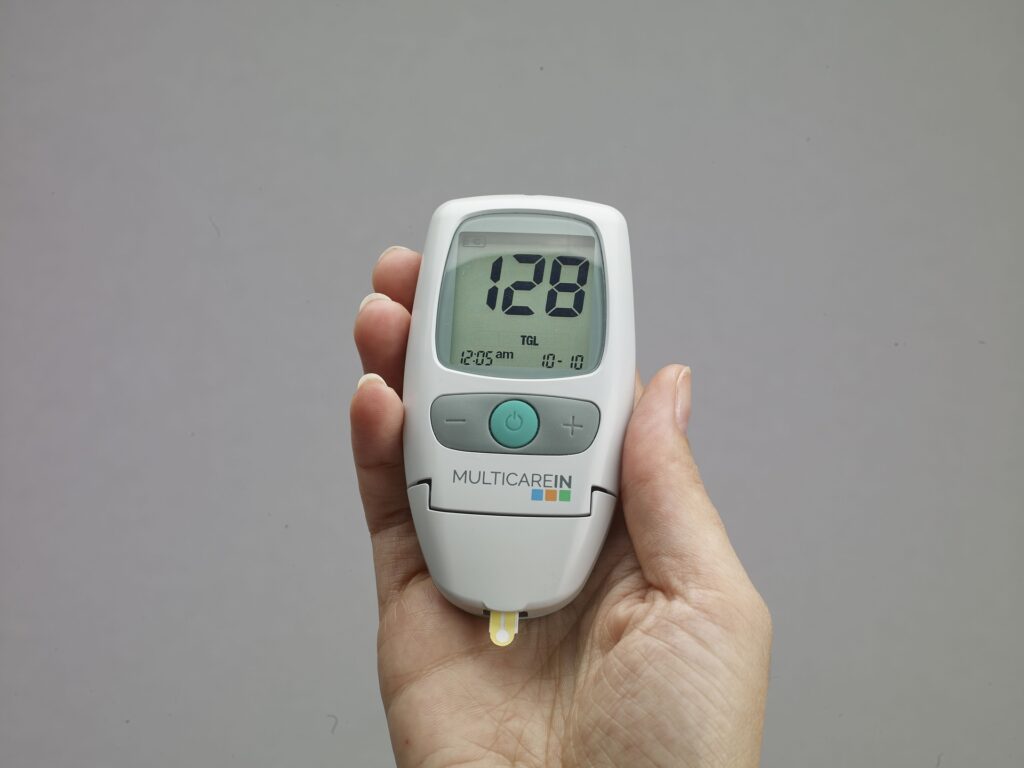 Glucometer showing a glucose reading of 128